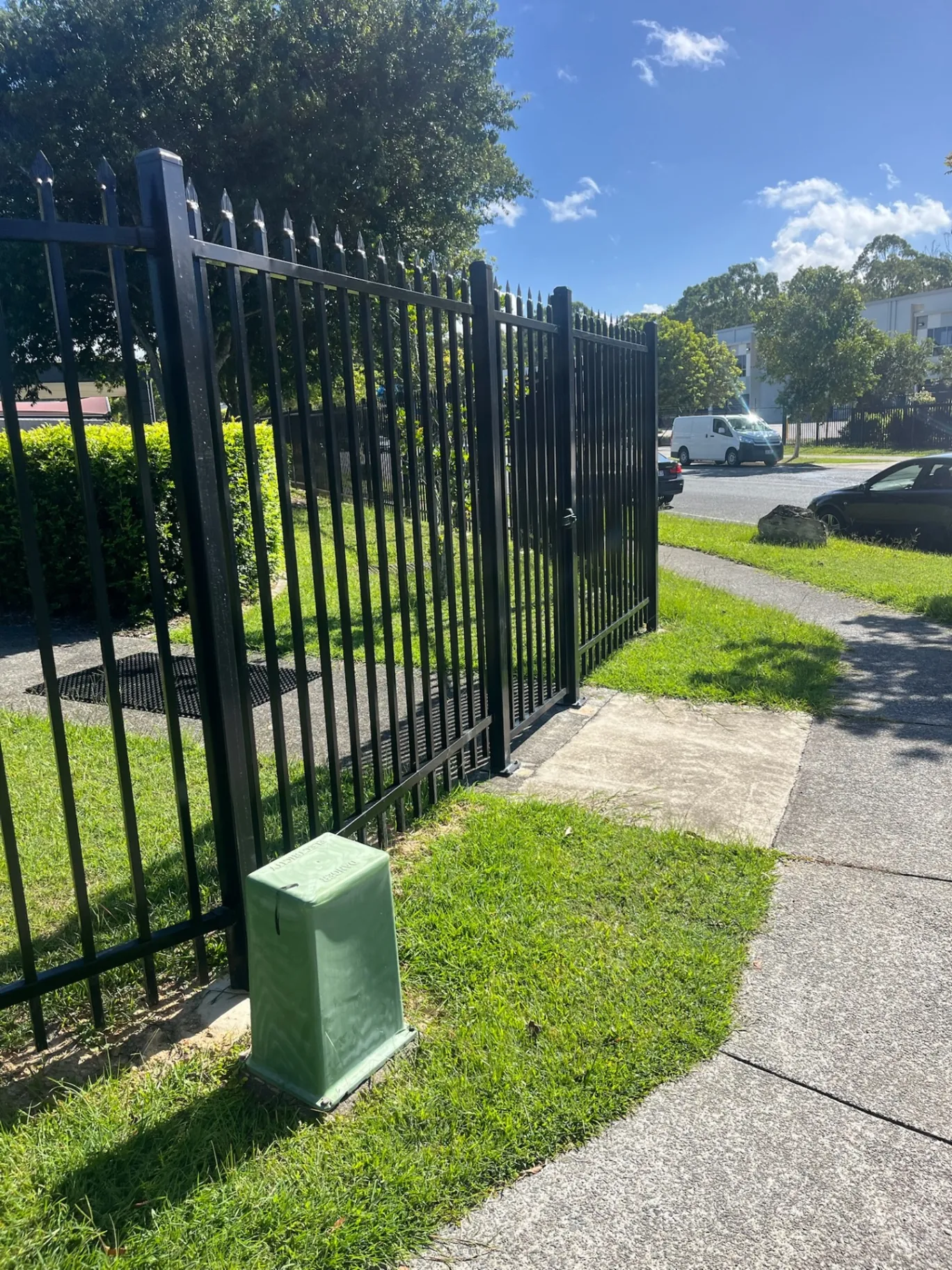 Black steel fencing and gate on a body corporate property boundary