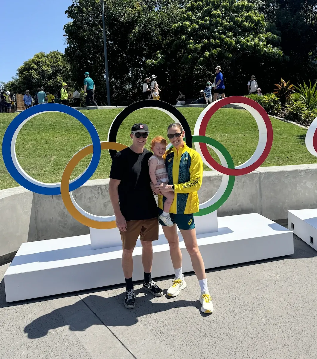 Alyce and Jordan Wood, founders of Wood Trades, in front of the Olympic rings