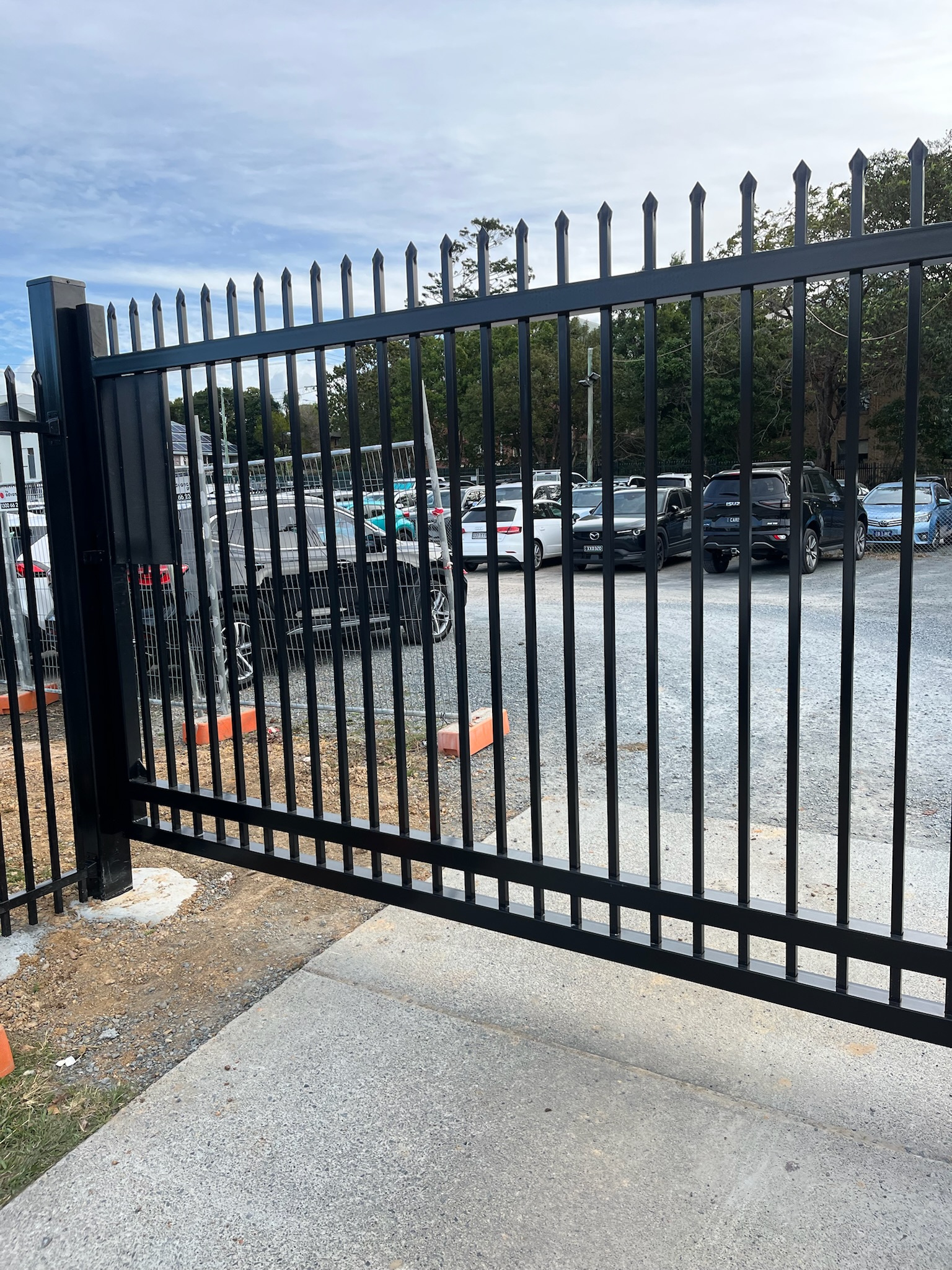 1200mm high black chainwire fence with posts grouted into core drilled Sandstone Block Wall - Wood Trades x QFence